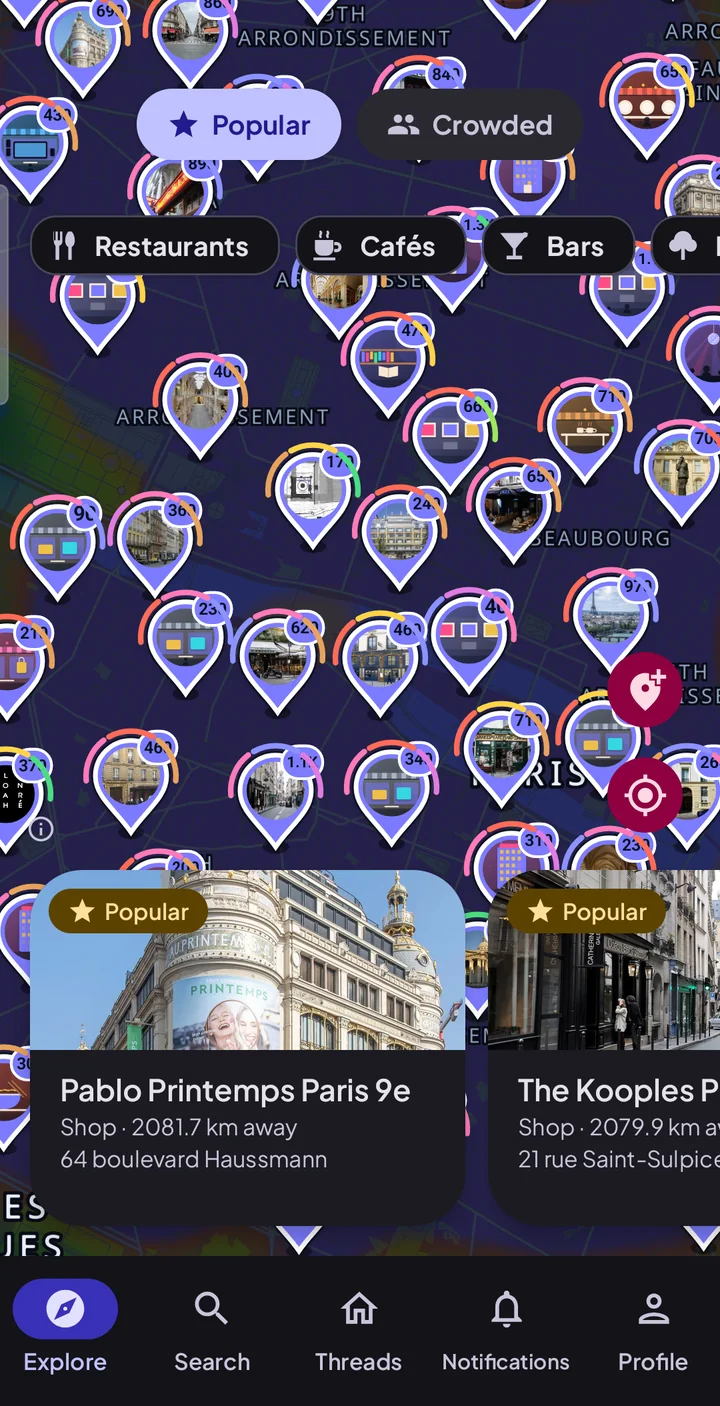 WhereToGo's Explore map over central Paris, every place with its own photograph and a count of what is around it